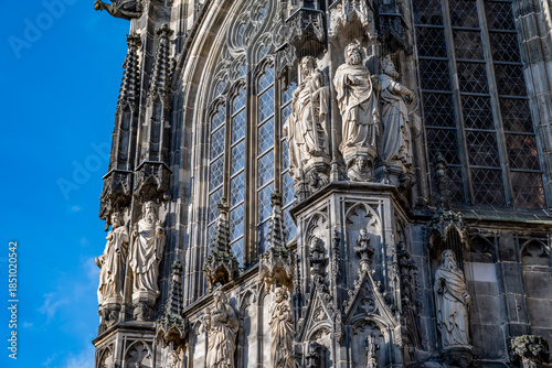 Gothic cathedral facade statues and stained glass window detail