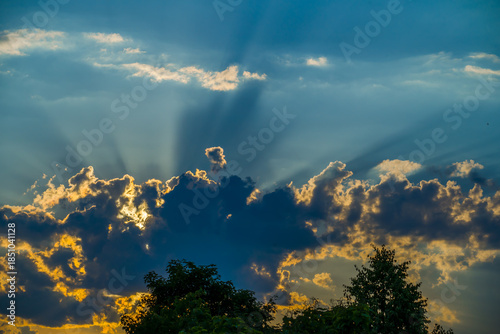 Sun rays behind a brightly lit cloud