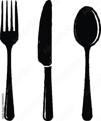 A set of shiny steel kitchen utensils and silver cutlery including a fork, spoon, and knife isolated on white for restaurant dining and food preparation