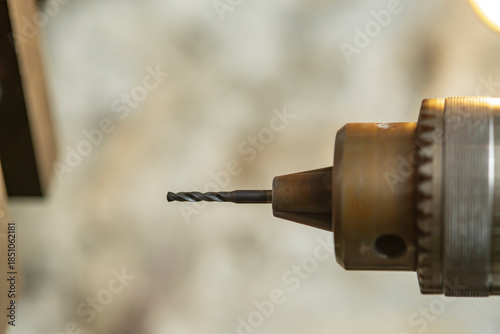 Milling machine cutting metal and wood with milling head, close-up.