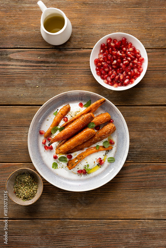 Top view of whole roasted carrots on plate