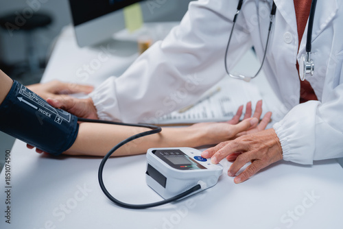 Doctor checking patient blood pressure measuring hypertension