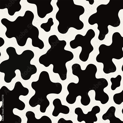 Seamless cow pattern with black and white organic spots inspired by animal hide texture in modern abstract style for fabric textile wallpaper surface design.