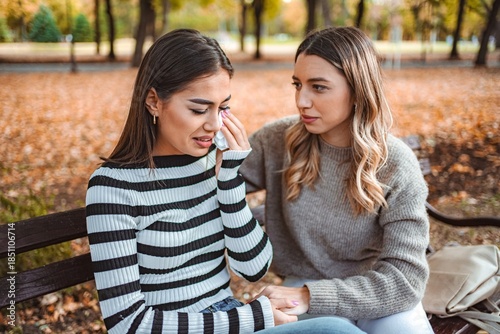 Εκτύπωση καμβά Girls sharing emotional moments in a serene autumn park setting