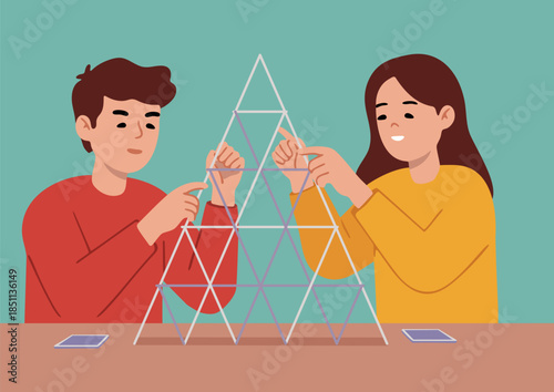 Man and woman are building a house of cards