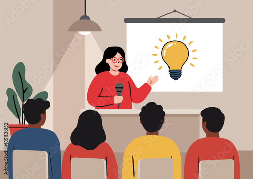 A speaker with a microphone speaking to an audience using demonstration material