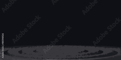 Dark and minimalist image featuring a circular textured gray area