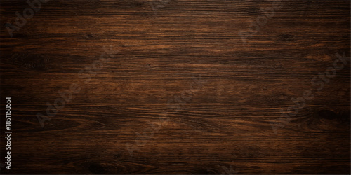 An old dark wooden background features a natural brown oak texture with a weathered plank pattern and timber grain surface for a rustic hardwood design