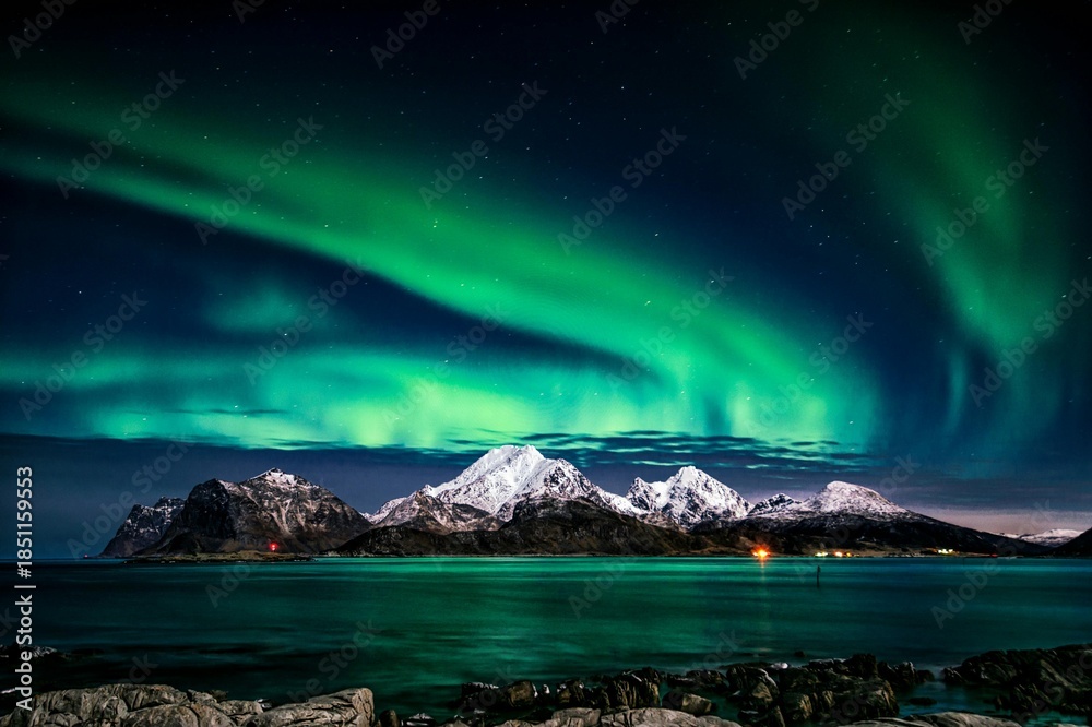 Naklejka premium Northern lights over snowy mountains
