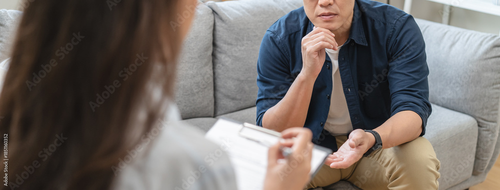 Fototapeta premium Man talking with mentor psychologist in therapy mental health anxiety session.