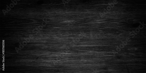 A dark grunge black chalkboard background with an old textured paper pattern and a rough aged surface for a vintage blank wall backdrop