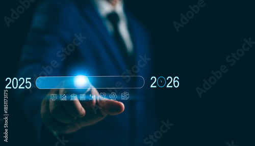 New Year 2026 Business start-up to goals, A businessman touches taps start-up button 2025 to 2026 for New Year 2026, sets goals, for develops strategies to achieve better results success in the future