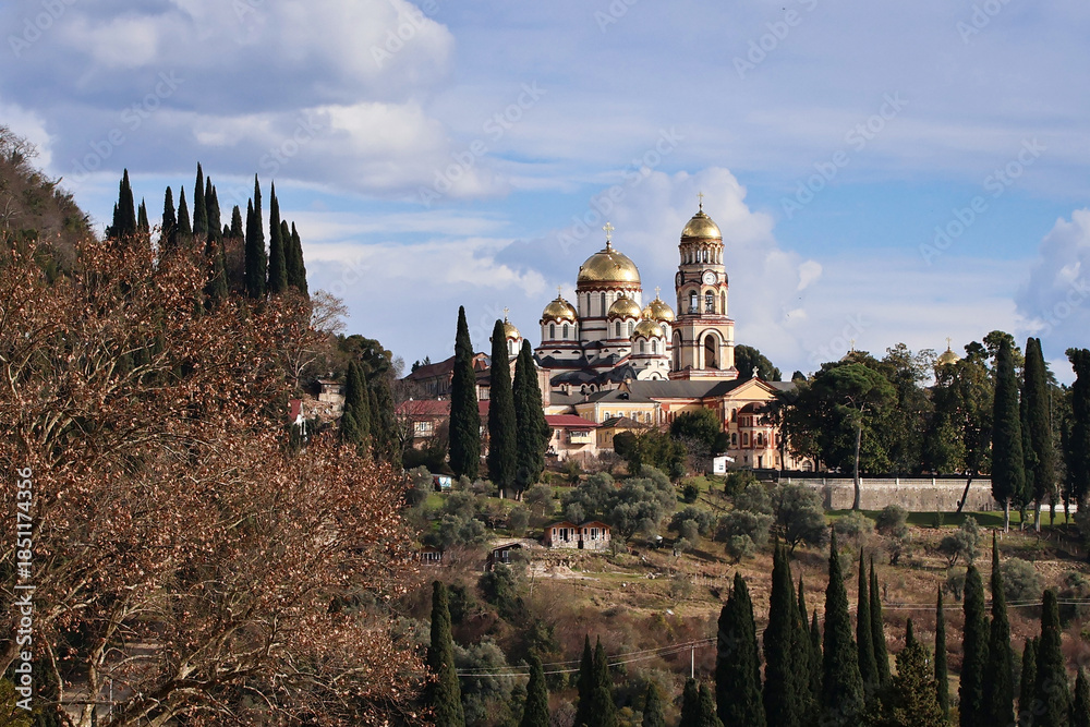 Obraz premium Panoramic view of New Athos Monastery in Abkhazia. Majestic Orthodox architecture surrounded by green hills and mountains, capturing spiritual heritage, scenic landscape and a famous Caucasus landmark
