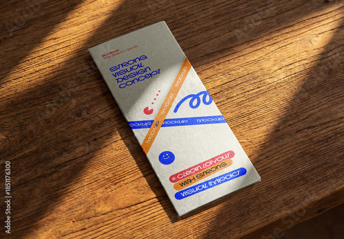 Template Mockup Vertical Flyer Branding and Identity Design on Wooden Surface with Natural Sunlight