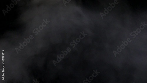 Abstract white smoke billowing on black background