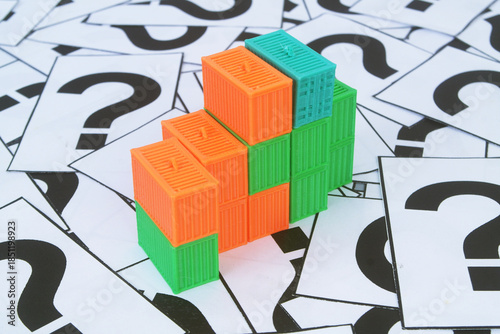 Many containers on question marks background. Shipping, delivery and ​​transportation questions concept.