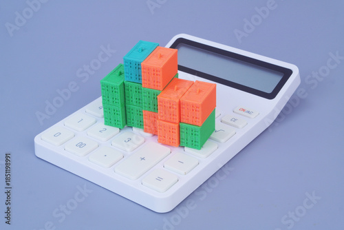 Many cargo containers on calculator on grey background. Shipping and transportation cost  concept.