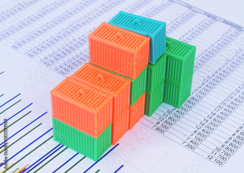 Many containers on financial reports. Cargo and logistics concept.