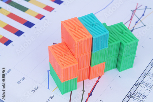 Many containers on financial reports. Cargo and logistics concept.