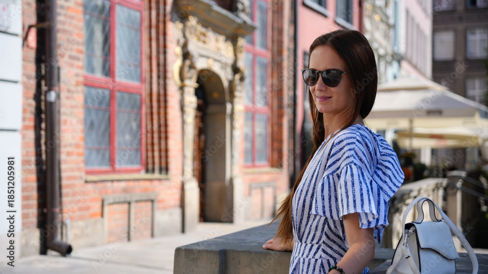 Fototapeta premium Young woman with sunglasses in historic Gdansk Old Town Poland