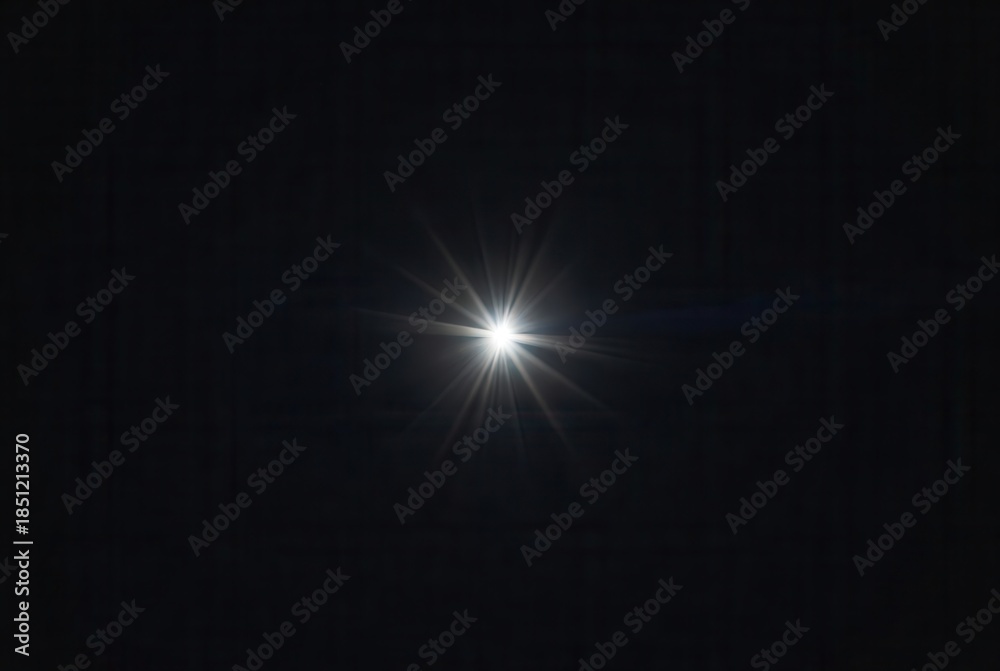Fototapeta premium Glow of a bright starburst light effect with brilliant rays and subtle lens flare