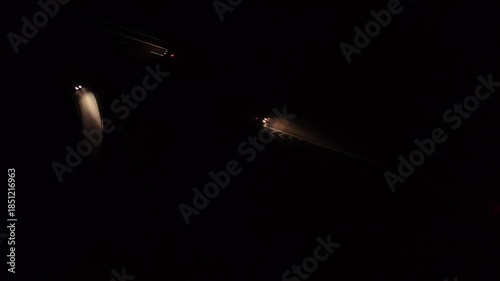 Aerial Night View of Moving Cars with Light Trails on Highway Interchange
