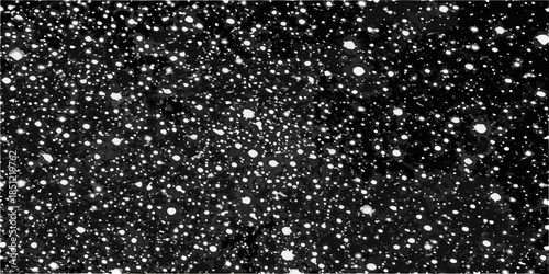 A black and white image depicting a field of scattered bright circular shapes