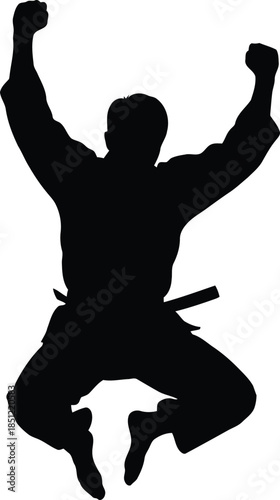 Martial artist silhouette jumping in celebration after achieving a significant victory