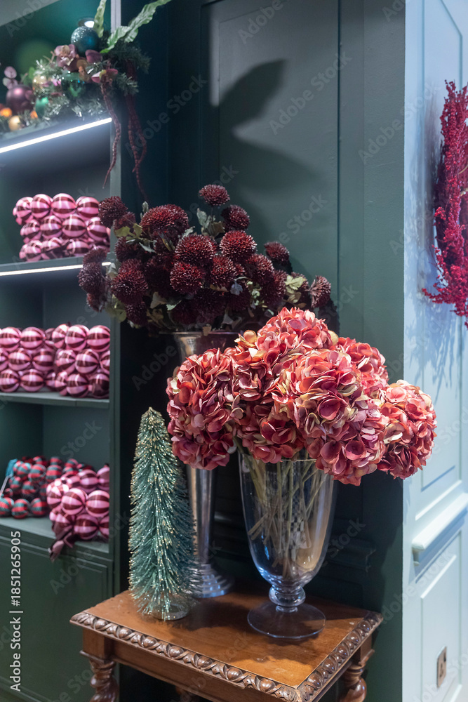 Fototapeta premium holiday floral arrangements and ornaments displayed on a wooden table