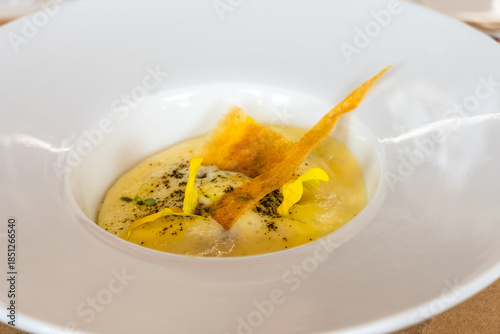 Elegant gourmet dish served in a modern white bowl, close-up shot