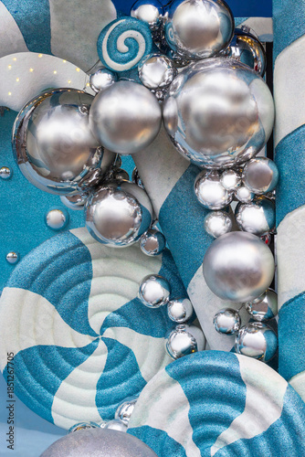 Festive New Year decoration with silver balls on a turquoise and white background.