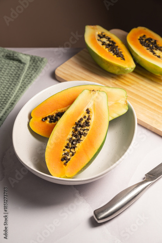 Papaya exotic fruit halves on plate. Healthy vegan food.