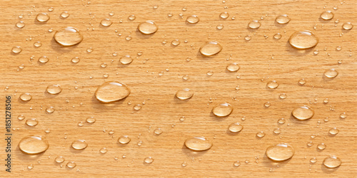 Macro droplets of clean aqua liquid create an abstract wet texture on a clear glass surface over a bright yellow background