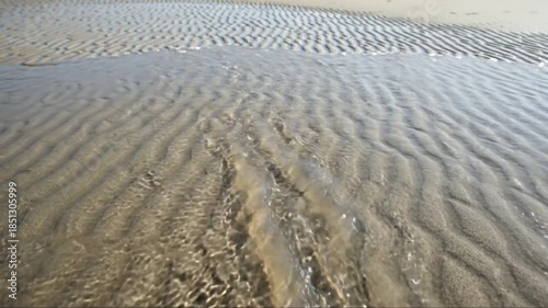 Serene beach ripples and tidal patterns creating a tranquil coastal landscape