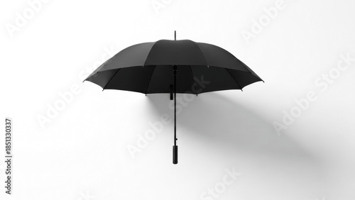 Single black umbrella suspended against a pristine white wall, casting a subtle shadow and turning a simple object into a crisp minimalist study of balance, contrast, and quiet design

