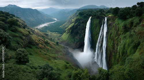 Aerial view, massive natural waterfall, lush green valley, misty atmosphere, dramatic landscape, river, mountain