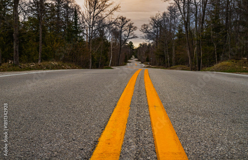 winding asphalt road with yellow lines