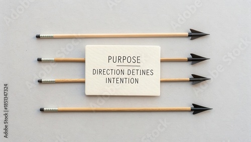 Wallpaper Mural Arrows Pointing Towards Card Displaying Words Purpose, Direction, and Intention on Minimalistic Background Torontodigital.ca