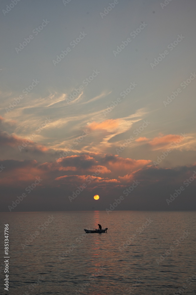 Fototapeta premium fishing boat at sunset