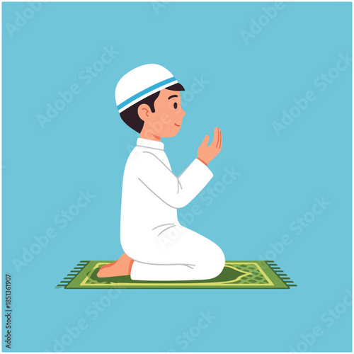 A young Muslim boy in a white thobe and kufi kneels on a green prayer mat with hands raised in prayer.