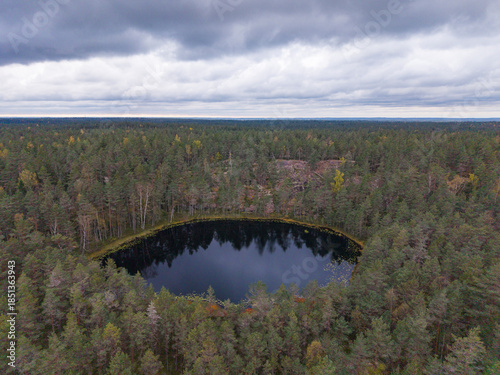 An aerial drone view to a forest lake in Finland