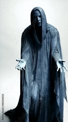 Mysterious Dark Figure in a Hooded Cloak on White Background.