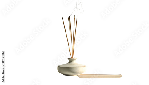 White ceramic diffuser vase holds reeds with Asian calligraphy & small wooden tray
