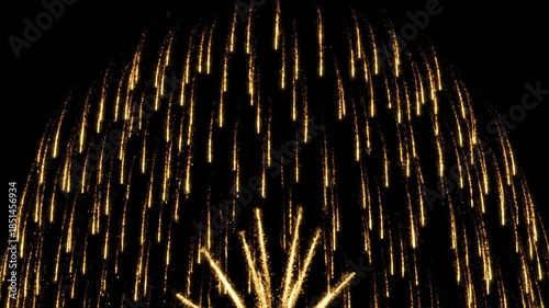 Golden Celebration: A mesmerizing sequence of vibrant gold fireworks exploding against a stark