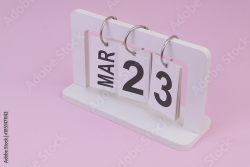 March 23 on calendar on pink background	