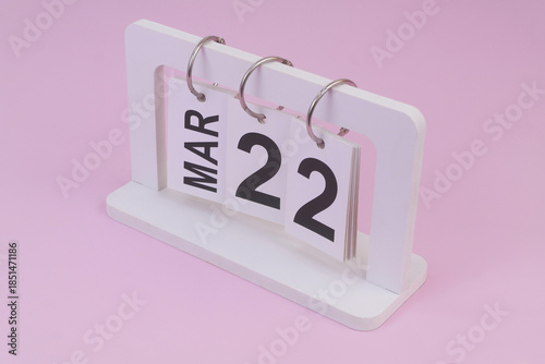 March 22 on calendar on pink background	