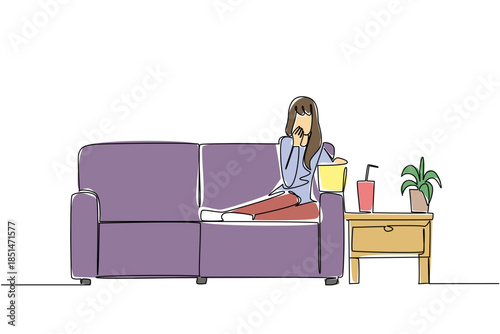 Continuous line drawing of a woman reclining on a couch, covering her face in fright while watching a movie, with popcorn and drink on side table, Celebrate National Movie Night as intense experience.