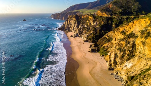 Scenic coastal vista with sandy beach, rocky cliffs, and turquoise water under a sunny sky