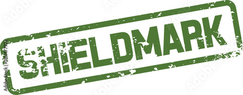 Distressed green rectangular rubber stamp with the bold uppercase word SHIELDMARK clearly visible