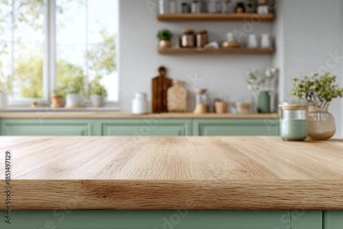 Bright, sunlit kitchen with wooden countertop and sage green cabinets
